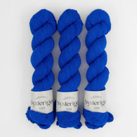 Sysleriget hand dyed yarn in single ply merino wool in the color True Blue.